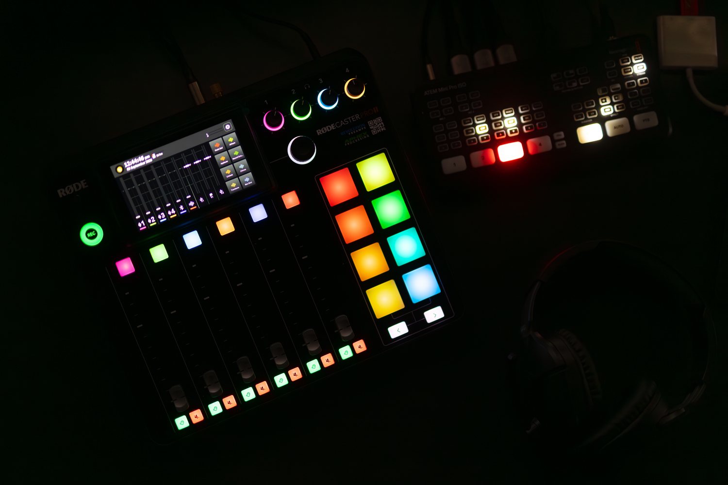 The Podhub control room mixing desk, lit faders and pads